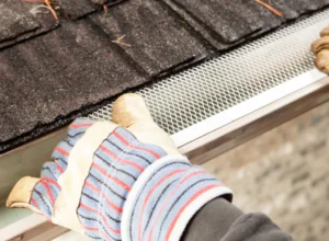 close up shot worker installing gutter guard
