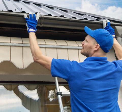 man installing gutter system