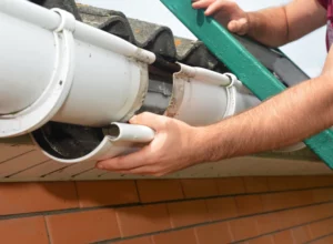 worker repairing a rain gutter